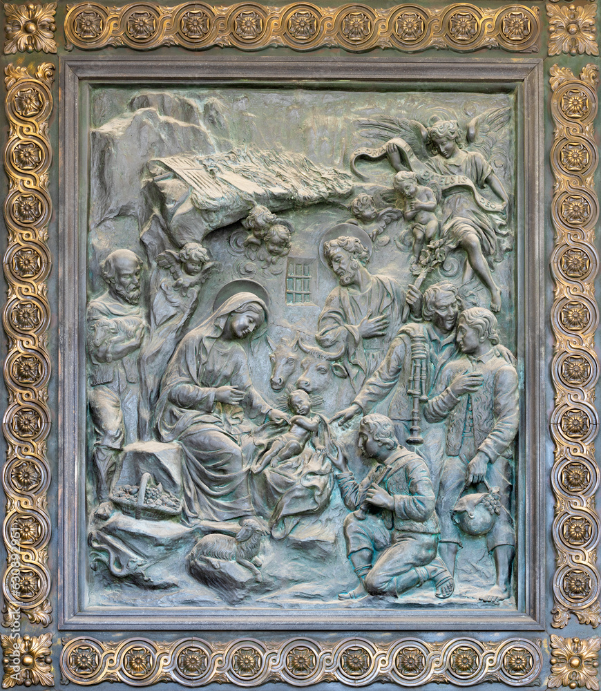 NAPLES, ITALY - APRIL 22, 2023:  The bronze relief of Adoration of Shepherds on the gate of church Basilica dell Incoronata Madre del Buon Consiglio from 20. cent.