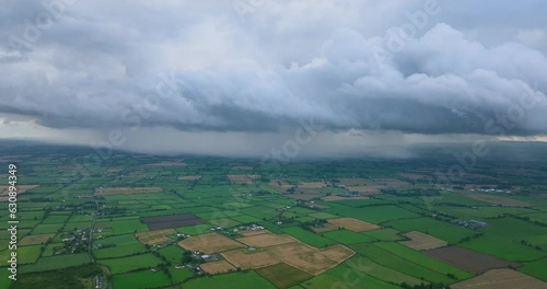 Rain against storm clouds, green fields of Ireland. photo