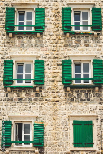 Green shutters on an old townhouse in southern Europe © Jakub