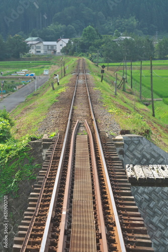 Akita, Japan - July 28, 2023: Single-track railway in rural zone in Akita, Japan
 photo