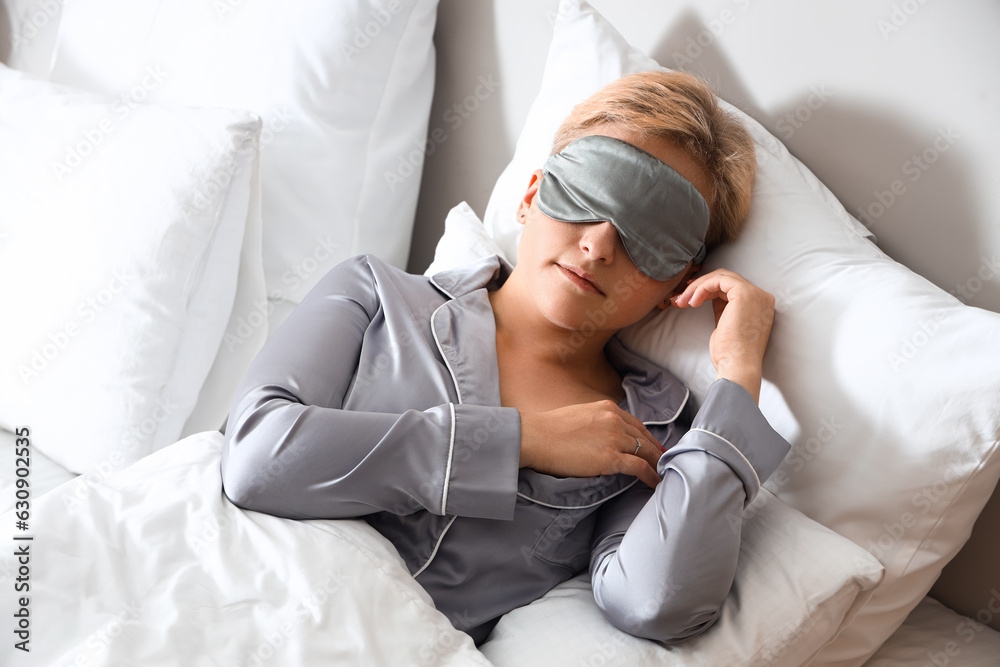 Young woman with mask sleeping in bed Young woman with mask sleeping in bed