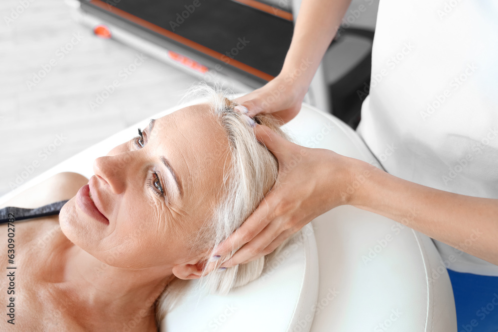 Female physiotherapist massaging mature woman in rehabilitation center, closeup Female physiotherapist massaging mature woman in rehabilitation center, closeup