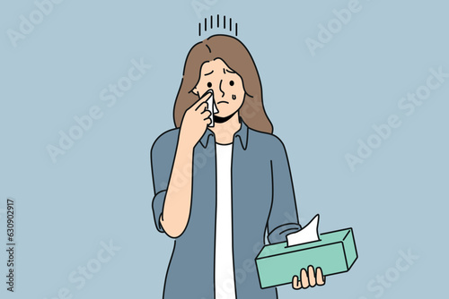 Crying woman wipes tears with paper napkins, experiencing stress and psychological suffering after breaking up with boyfriend. Crying girl holding box of disposable towels needing help of psychologist