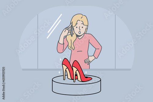 Woman looks at shop window with high-heeled shoes and dreams of updating wardrobe and going shopping. Girl is surprised to learn about discounts or promotions for purchase of shoes.