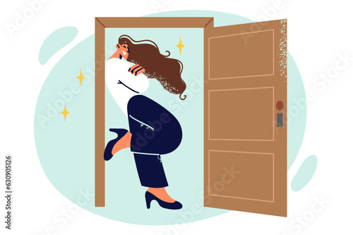 Hospitable woman stands near open door and smiles as she sees off boyfriend after date