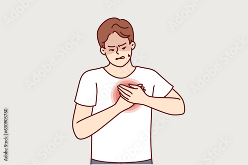 Man feels heartache suffering from cardio ailments and clutching chest during attack. Guy with heartache needs trip to hospital and professional examination by cardiologist doctor.