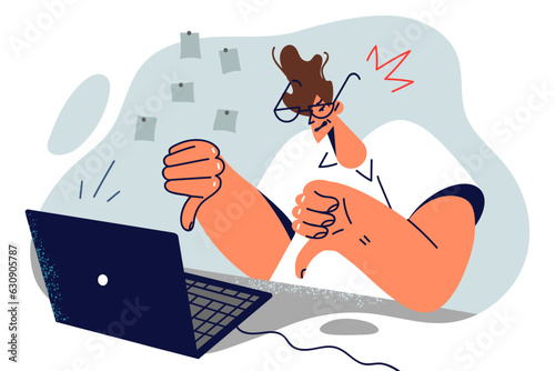 Dissatisfied man showing thumbs down sitting near laptop and calling for fixing software bugs