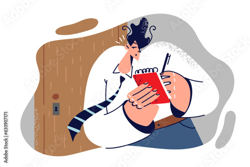 Man is spying on competitors standing at door and writing down overheard secrets in notebook