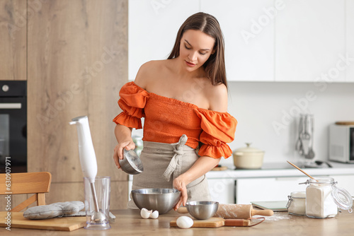 Young woman preparing dough...