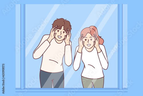 Man and woman look through glass showcase to examine product they like or follow customers of store. Curious couple near supermarket showcase or window, with smile spying on neighbors