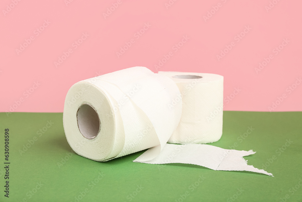 Fototapeta premium Rolls of toilet paper on colorful background