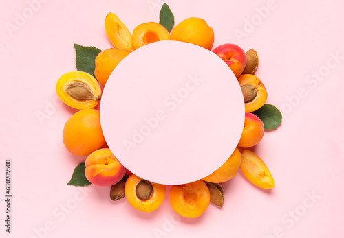 Blank card and sweet apricots on pink background