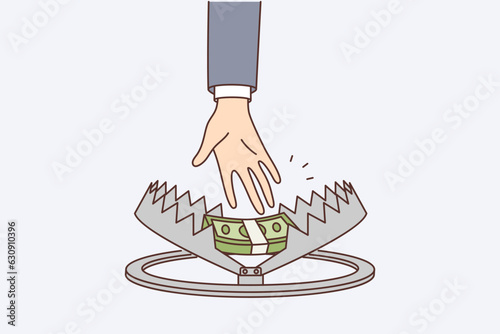 Person hand reaches for money in trap, symbolizing risky income or danger when taking mortgage