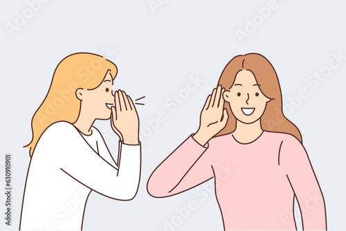 Woman screams to tell interesting news to female friend, puts hand to ear during conversation