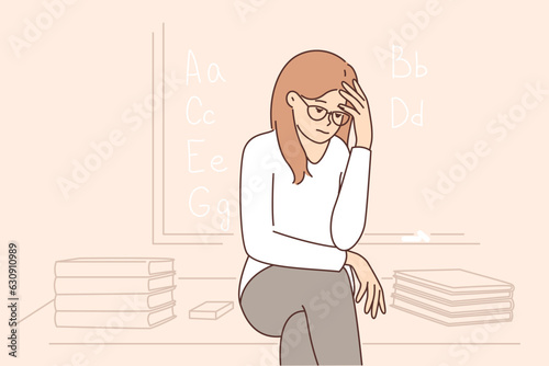Sad girl sits near blackboard and gets upset because of lack of prospects after receiving education