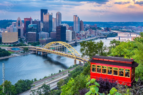 Red car of Duquesne Incline with Pittsburgh downtown panorama on background at sunset