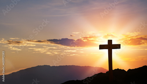 Holy concept: Silhouette wooden cross on mountain sunset background