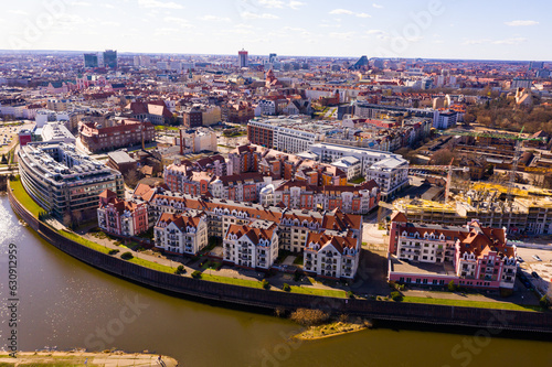 Aerial view of Poznan modern residential areas on bank of Warta River on sunny spring day, Poland