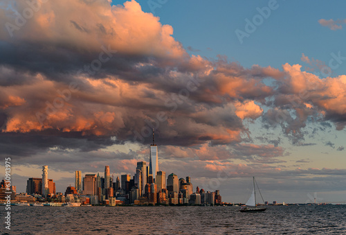 Sunset clouds and sailboat with New York City skyline from Hoboken