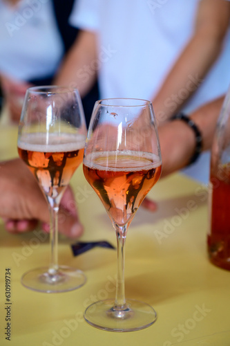 Tasting of sparkling rose wine with bubbles champagne on summer festival route of champagne in Cote des Bar, Champagne region, France © barmalini