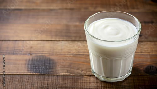 Photos Kefir, buttermilk or yogurt in glass on wooden desk