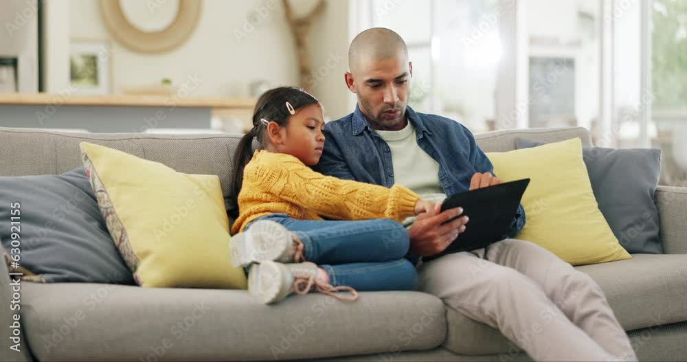 Tablet app, games and a dad with his daughter on a sofa in the home living room for education or learning. Kids, support and motivation with a father teaching his girl child while sitting together Tablet app, games and a dad with his daughter on a sofa in the home living room for education or learning. Kids, support and motivation with a father teaching his girl child while sitting together