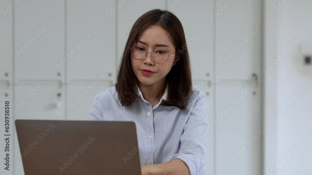 Asian Businesswoman Using laptop computer and working at office with document on desk. Asian Businesswoman Using laptop computer and working at office with document on desk.