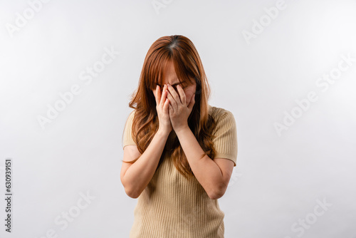 Portrait of displeased offended young Asian woman looks angrily aside doesnt agree with somebodys opinion wears cream clothes isolated over white background