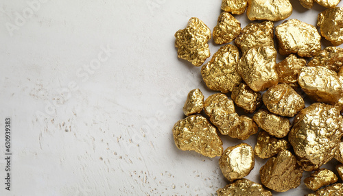 Foto Pile of shiny gold nuggets on white textured table, flat lay