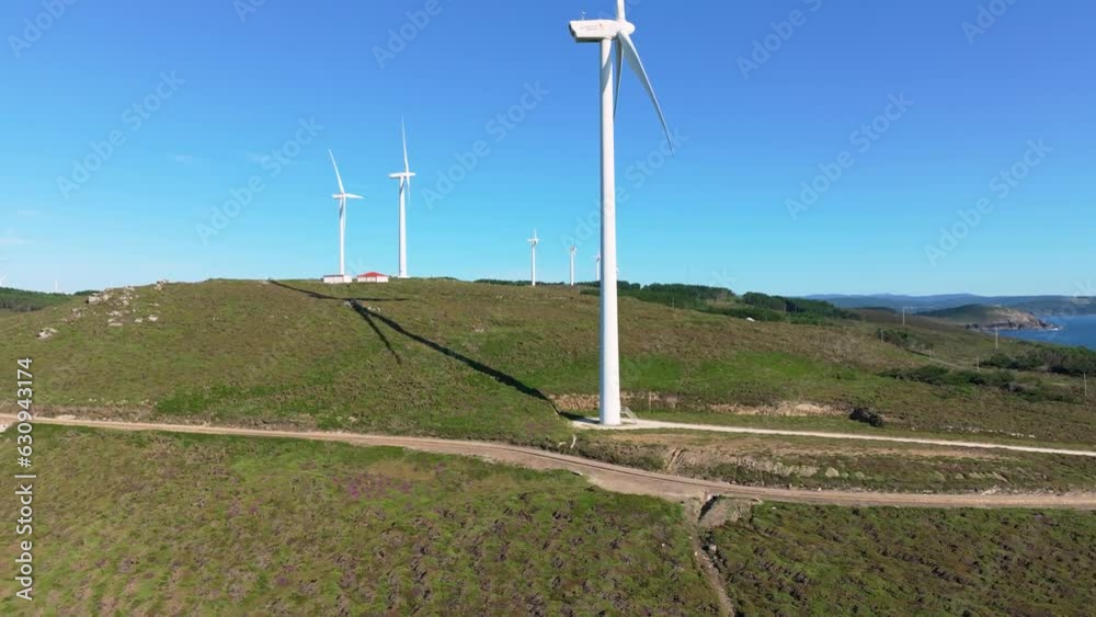 Windmills In Scenic Fields In The Galician Coast In Spain - aerial drone shot Windmills In Scenic Fields In The Galician Coast In Spain - aerial drone shot