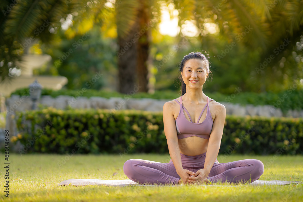 Asian woman wearing yoga clothes doing yoga at her village garden in the morning, happily, Sports healthy lifestyle concepts, Japanese concepts.