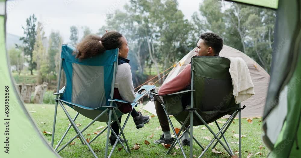 Tent, relax or couple camping in nature on holiday vacation or fun weekend break at countryside together. Chair, back or man with woman bonding, talking of speaking in park, forest or woods outdoors Tent, relax or couple camping in nature on holiday vacation or fun weekend break at countryside together. Chair, back or man with woman bonding, talking of speaking in park, forest or woods outdoors