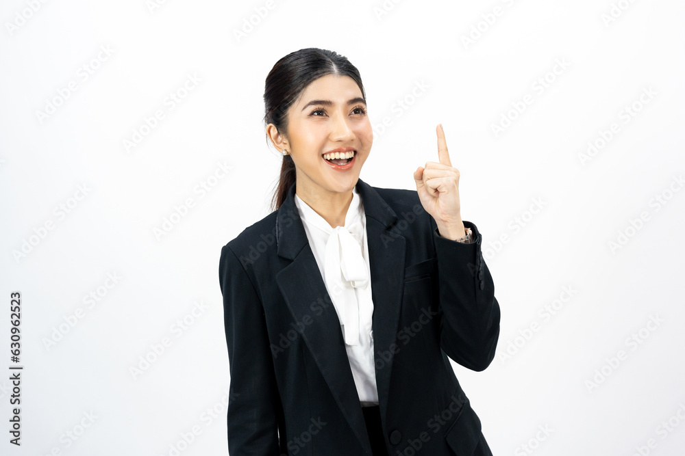 Young asian business woman happy smiling pointing finger to blank space on isolated white background. Female around 25 in suit portrait shot in studio. Young asian business woman happy smiling pointing finger to blank space on isolated white background. Female around 25 in suit portrait shot in studio.