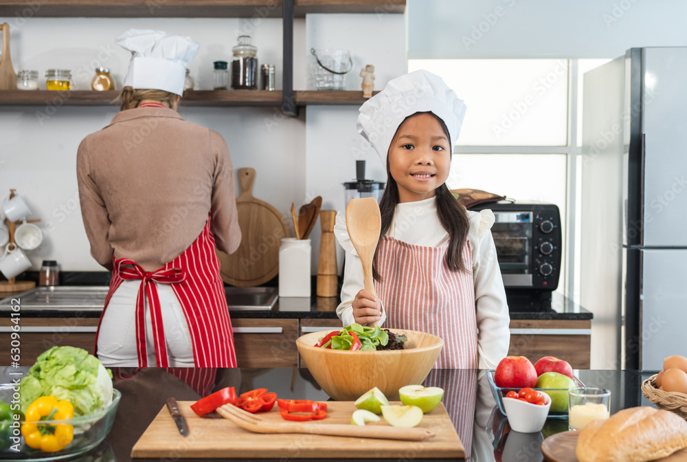 Happy moment asian mother and daughter cooking breakfast salad in the kitchen. Mom and daughter asian family having fun preparing healthy food vegetable. Positive parent and kid nice relationship Happy moment asian mother and daughter cooking breakfast salad in the kitchen. Mom and daughter asian family having fun preparing healthy food vegetable. Positive parent and kid nice relationship