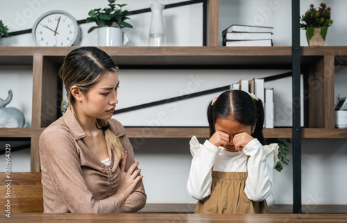 Angry mother scolding and punishing a disobedient daughter. Girl does not listen to mom. Family relationships concept