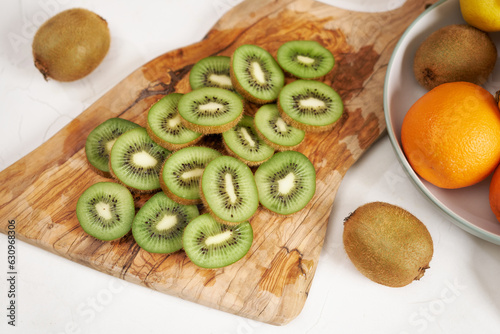 Fresh Sliced organic kiwi on wooden cutting board