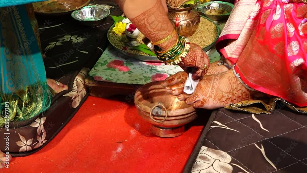 Applying Hindu Swastik on a bride legs in marriage ritual. Marathi Wedding Ceremony. Indian Marriage. Swastik As Symbol Of Sun. Hindu Religion Symbol	