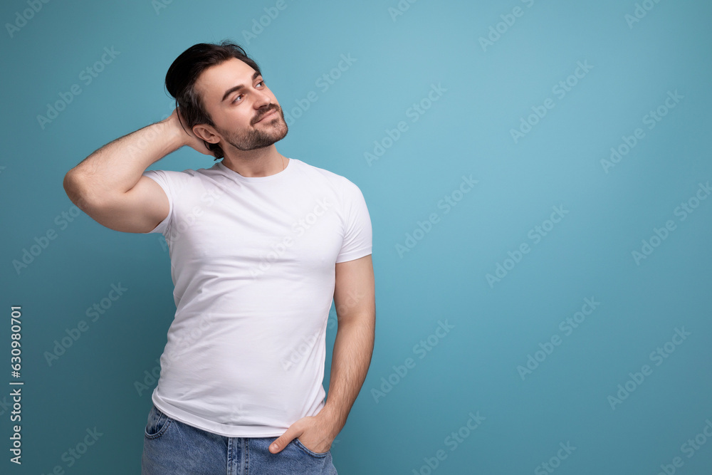 smart young man in a white t-shirt with an idea on a studio background with copyspace smart young man in a white t-shirt with an idea on a studio background with copyspace