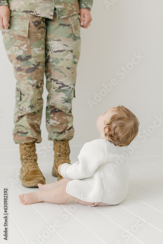 baby looking up at active duty mlitary mom in uniform photo