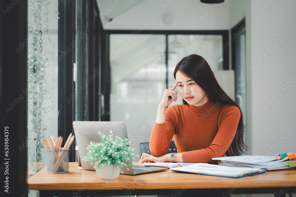 Woman stressed while working on laptop, Tired asian businesswoman with headache at office, feeling sick at work, copy space Woman stressed while working on laptop, Tired asian businesswoman with headache at office, feeling sick at work, copy space