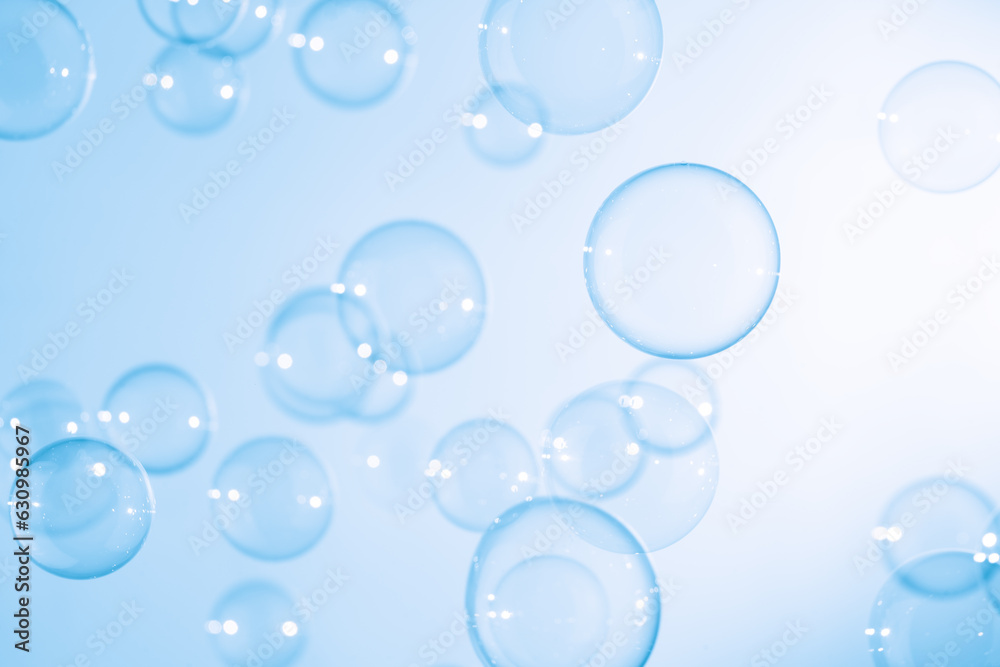 Beautiful Transparent Blue Soap Bubbles Floating in The Air. White Space, Abstract Fun Background, Blue Gradient Blurred Background, Refreshing of Soap Suds Bubbles Water.