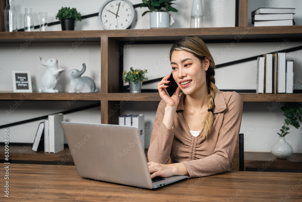 Young asian business woman working at office. Smiling charming happy young female doing work meeting conference with team at home. Using laptop Young asian business woman working at office. Smiling charming happy young female doing work meeting conference with team at home. Using laptop