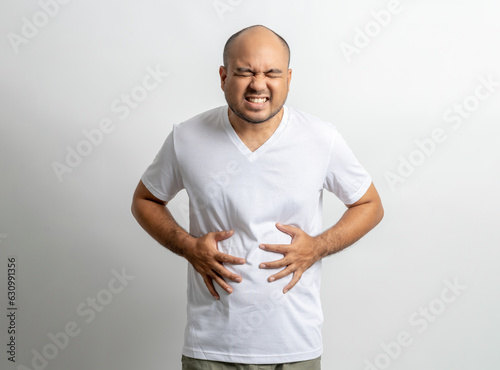 Man had a stomach ache and gastritis. He put hand on his stomach and squeezed it to relax and soothe has go to toilet need to poop