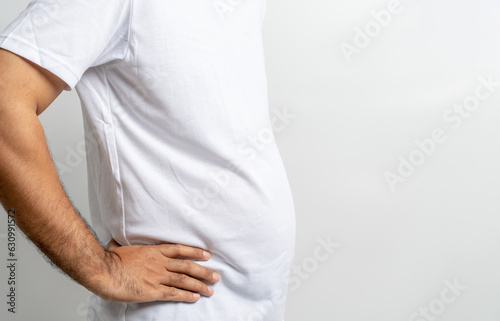Man touching his fat belly on white background. Paunch of a man. Overweight photo