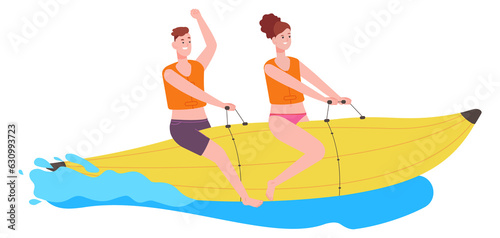 Happy people ride banana boat in water waves