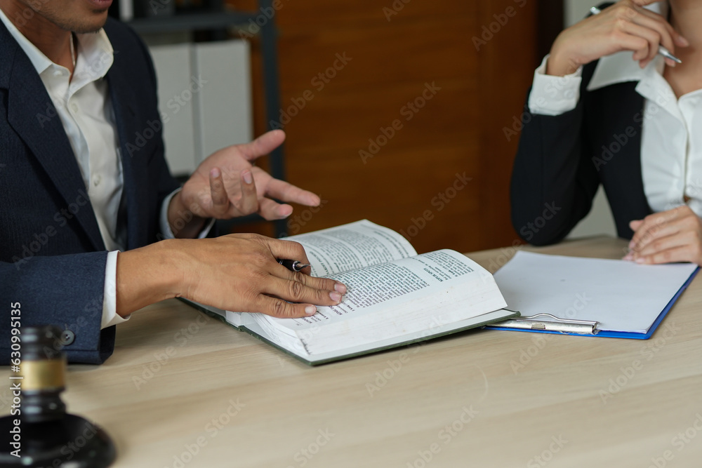judge on wooden table And experienced lawyers meet with clients and give advice behind the scenes. legal services legal consulting concept judge on wooden table And experienced lawyers meet with clients and give advice behind the scenes. legal services legal consulting concept