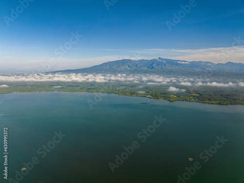 Tropical Island with blue sea and cloudscape over the mountain. Lanao del Norte. Mindanao, Philippines. photo