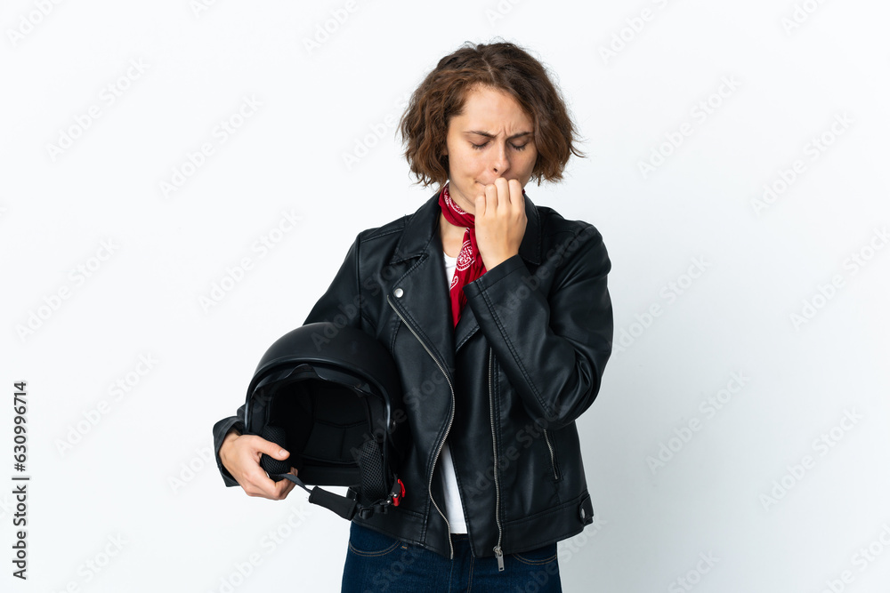 English woman holding a motorcycle helmet isolated on white background having doubts English woman holding a motorcycle helmet isolated on white background having doubts