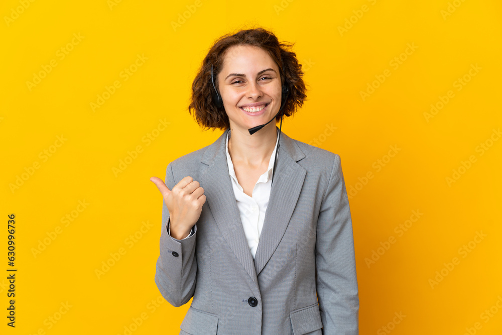 Young English woman isolated on yellow background pointing to the side to present a product Young English woman isolated on yellow background pointing to the side to present a product