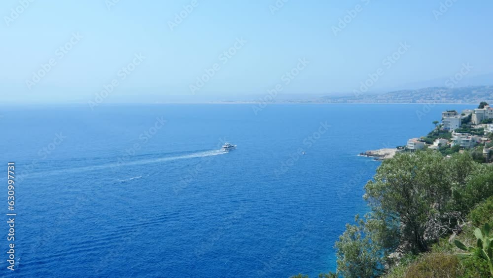 High angle view of scenic Nice shoreline with yacht cruising in Mediterranean High angle view of scenic Nice shoreline with yacht cruising in Mediterranean